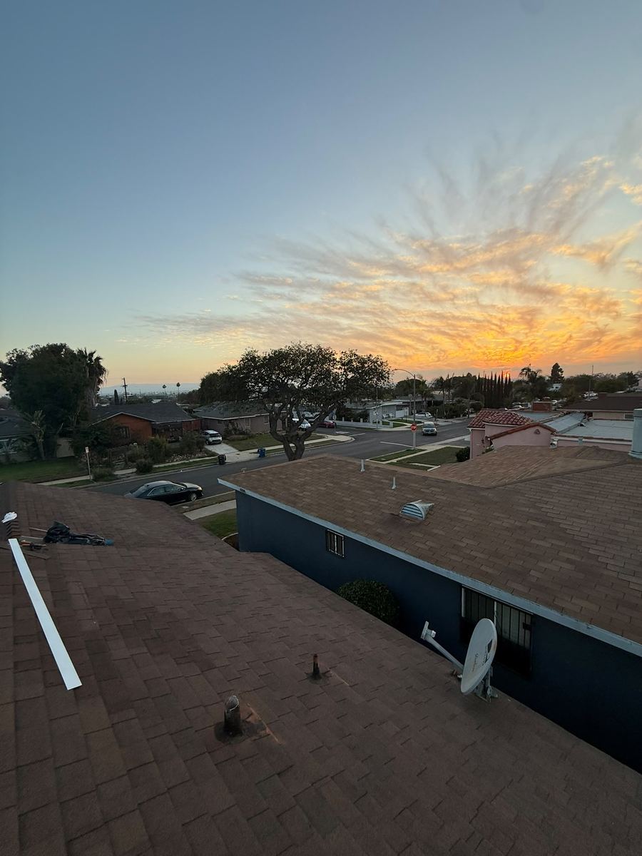 Sunset over a completed roofing project