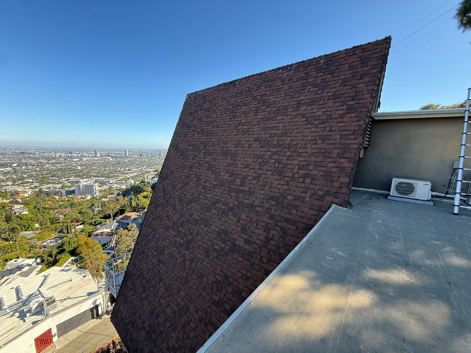 CaliPeak roofer overlooking Los Angeles from a new shingle roof
